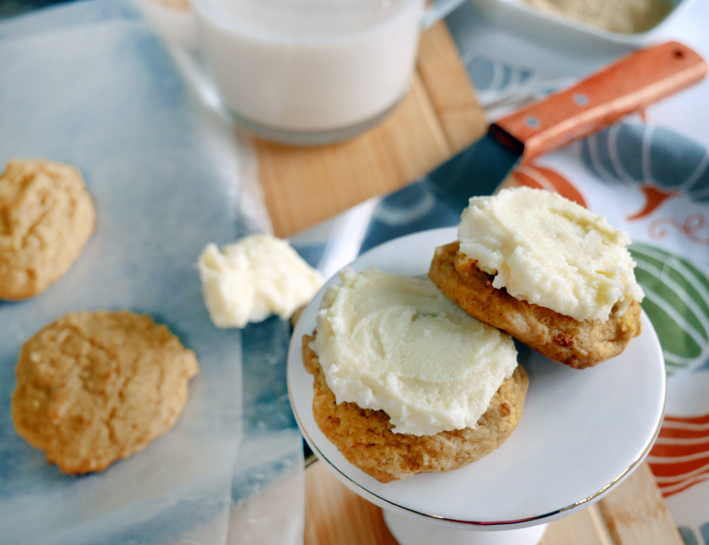 These soft-baked pumpkin cookies have the light, rich texture of butter cake & maple cinnamon cream cheese frosting for perfect fall flavor.