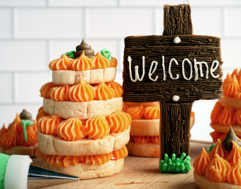 No spread cut-out sugar cookie stacks with buttercream into 3D pumpkins.