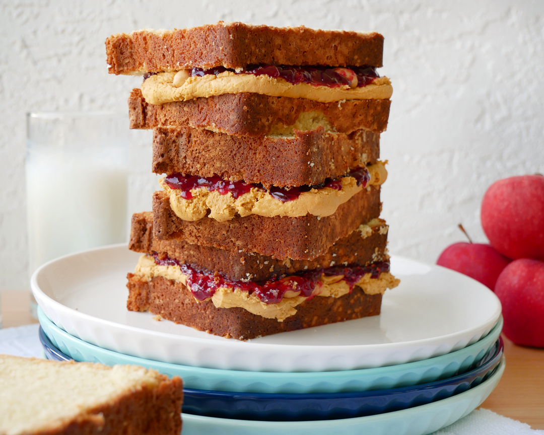 Cake made out of pound cake, peanut butter buttercream, jelly, and peanuts, but it looks like a stack of peanut butter and jelly sandwiches.