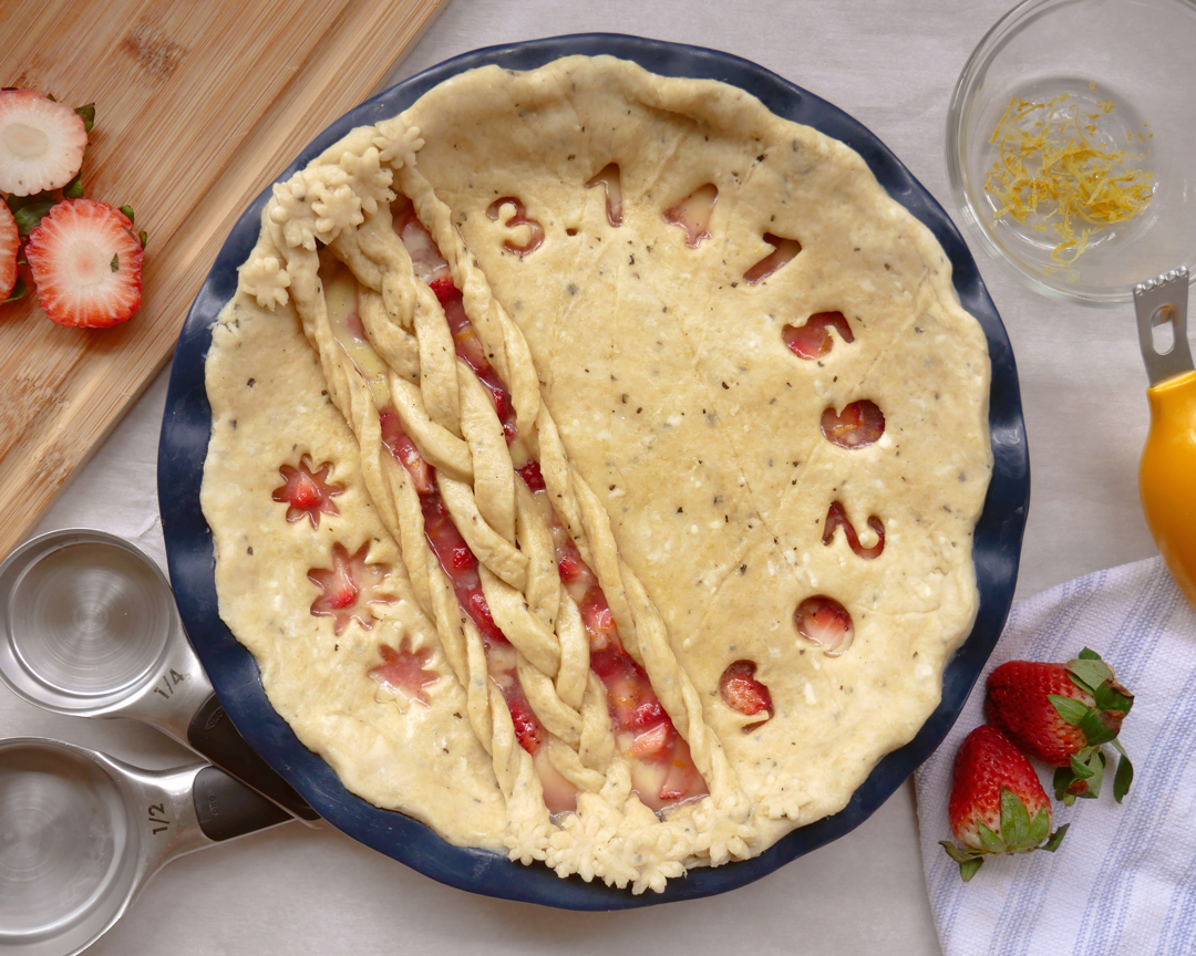 Strawberry Custard Pie with Homemade Basil Pie Crust - decorated with pie crust braids, pie crust flowers, and Pi cut out.