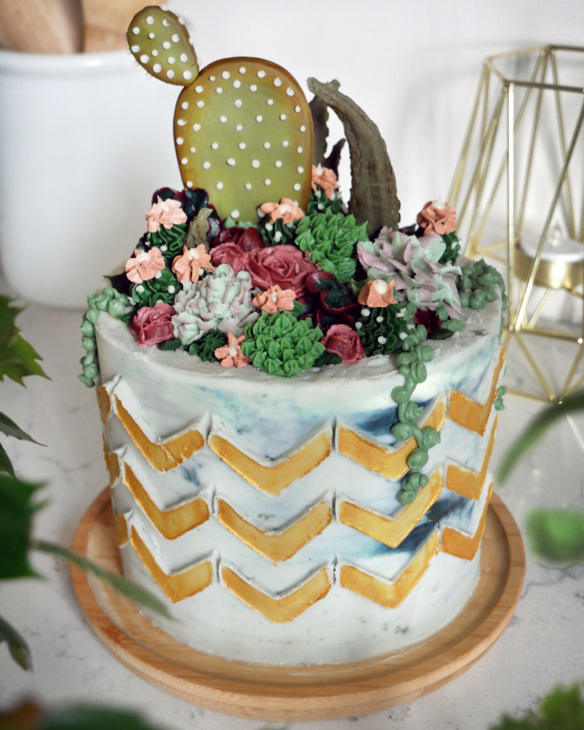 buttercream succulent flower cake with gold chevron stenciling cake