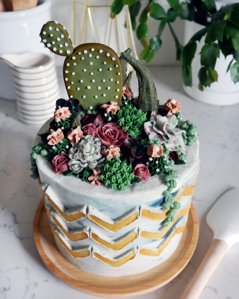 buttercream succulent flower cake with gold chevron stenciling cake