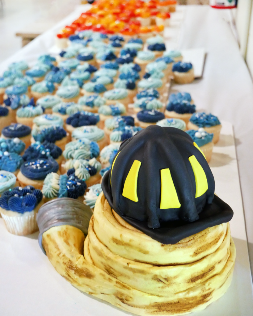 fire fighter's helmet made of cake and fire fighter's hose made of cake with fire and water cupcakes