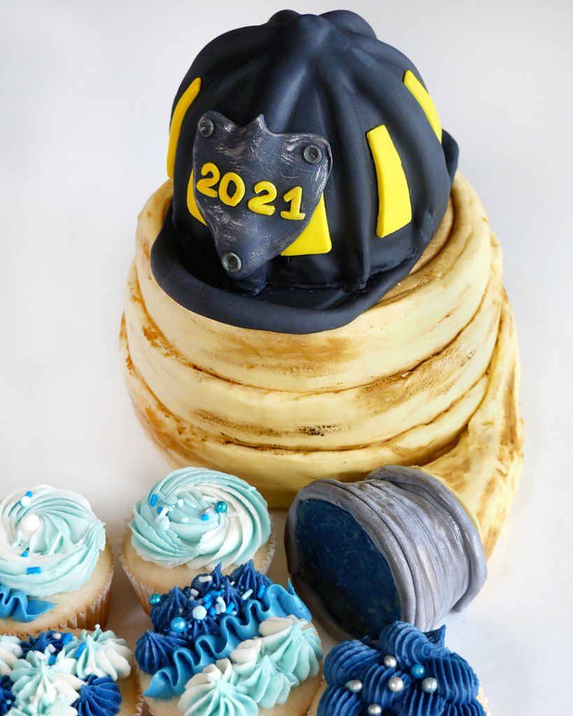 fire fighter's helmet made of cake and fire fighter's hose made of cake with fire and water cupcakes